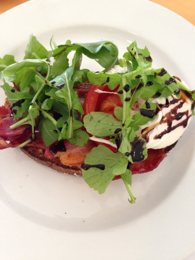 Toast with poached egg, tomato, BACON, and arugula